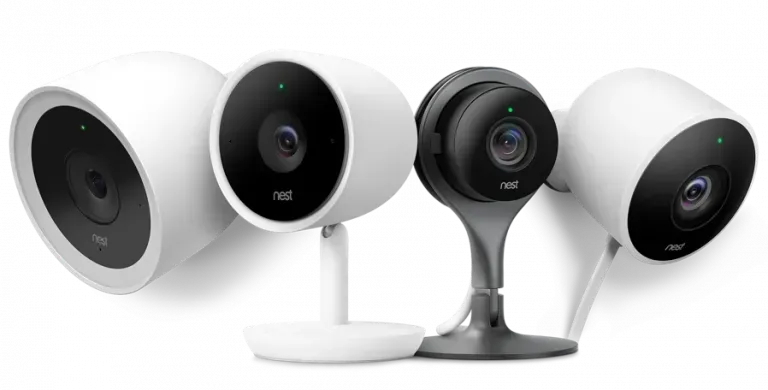 Four sleek white and black security cameras displayed in a row on a white background
