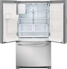 Open stainless steel French-door refrigerator with freezer drawer, shelves visible inside