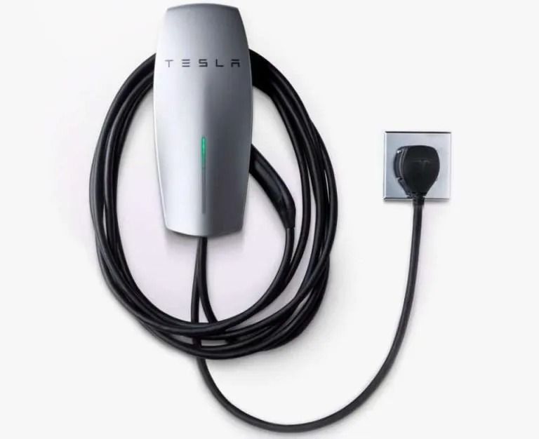 Tesla electric vehicle charging cable coiled around a silver wall-mounted charger unit