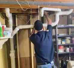 A plumber using a video inspection camera inside a pipe. - drain cleaning special near me