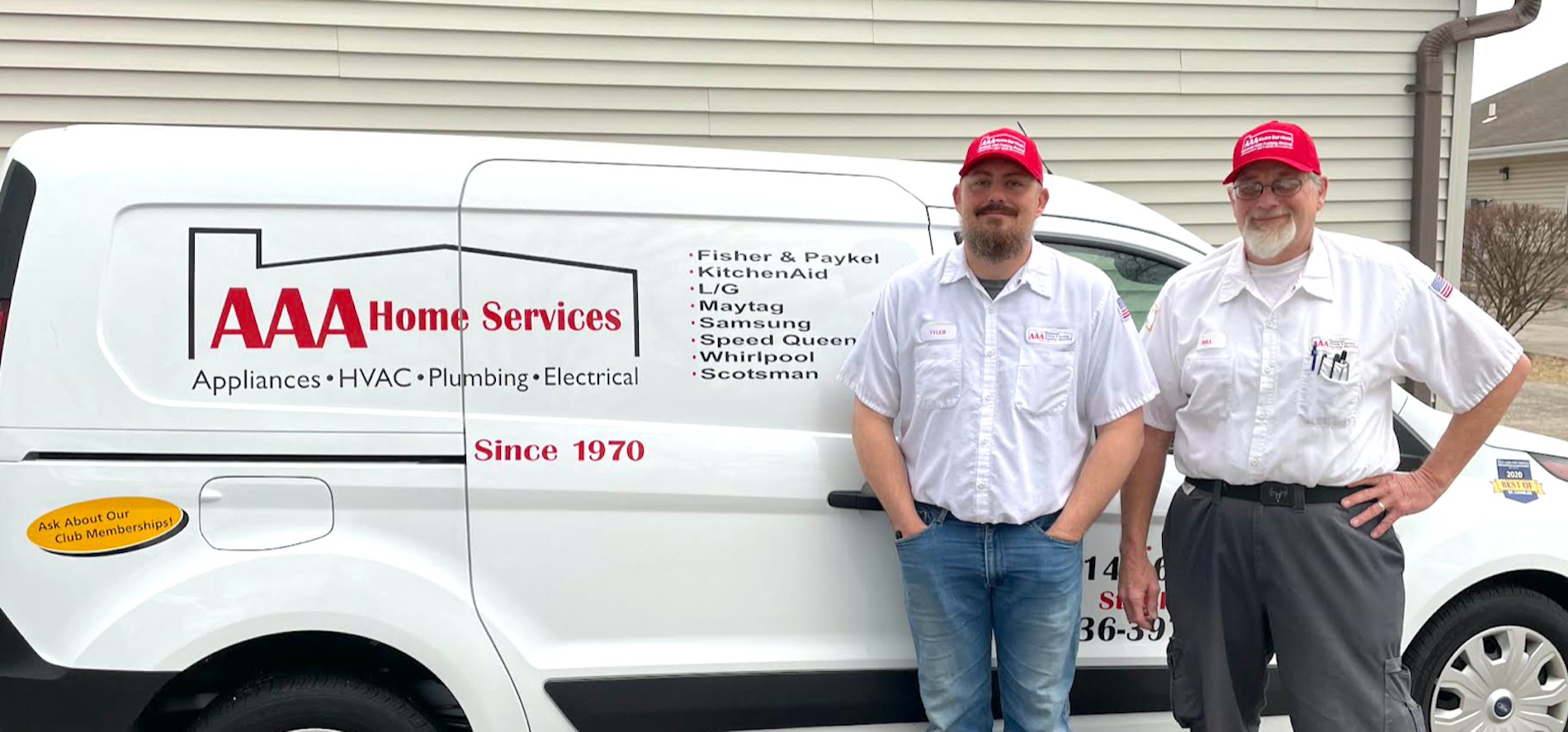 Two men in uniforms standing beside an AAA Home Services van