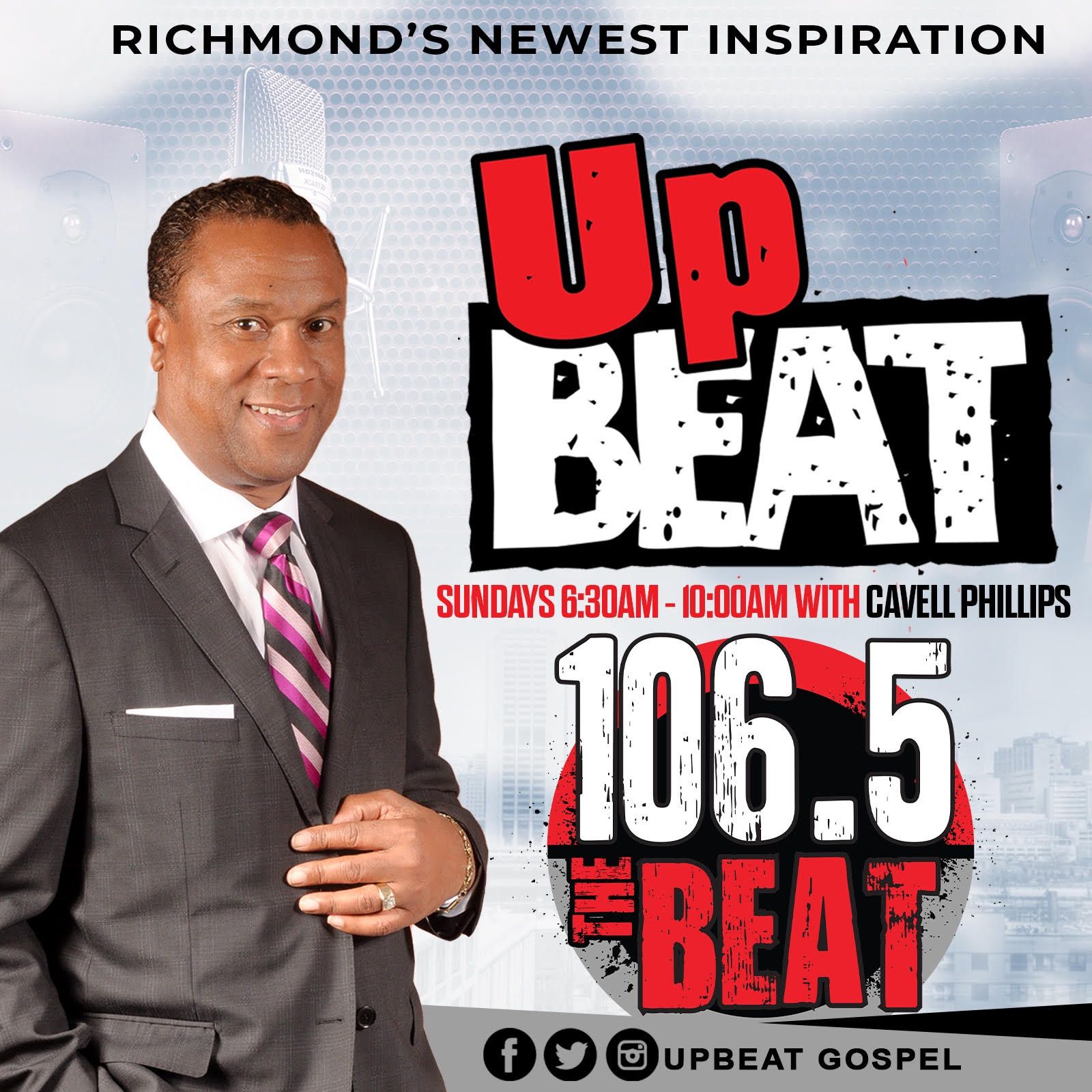 A man in a suit and tie stands in front of a poster for upbeat 106.5