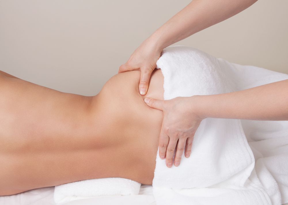 Massage Therapist's Hands on A Person's Hip — R & R Relaxation and Remedial In Yamba, NSW