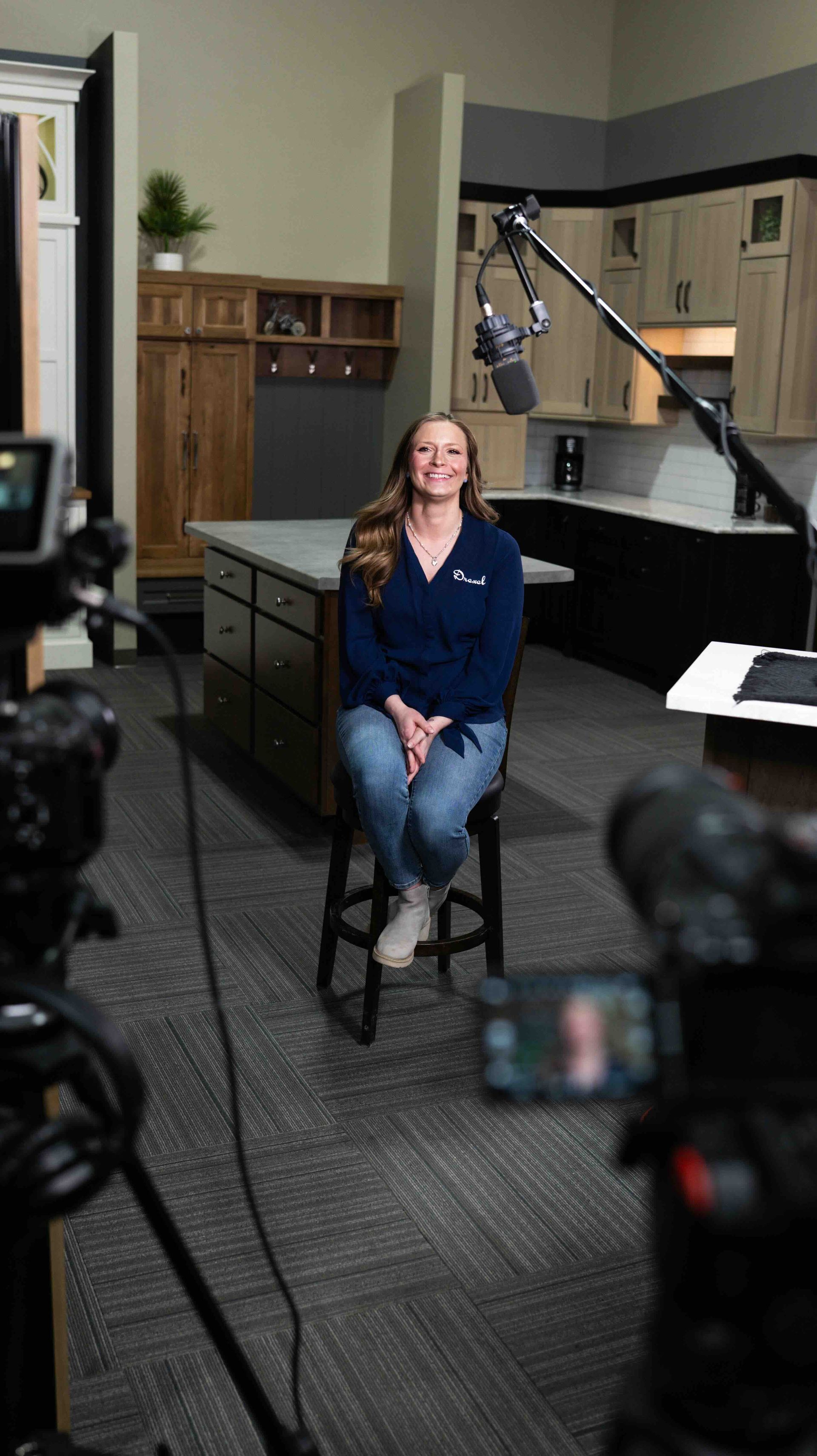 Behind-the-scenes commercial video production at Drexel Building Supply with professional lighting and filming equipment.