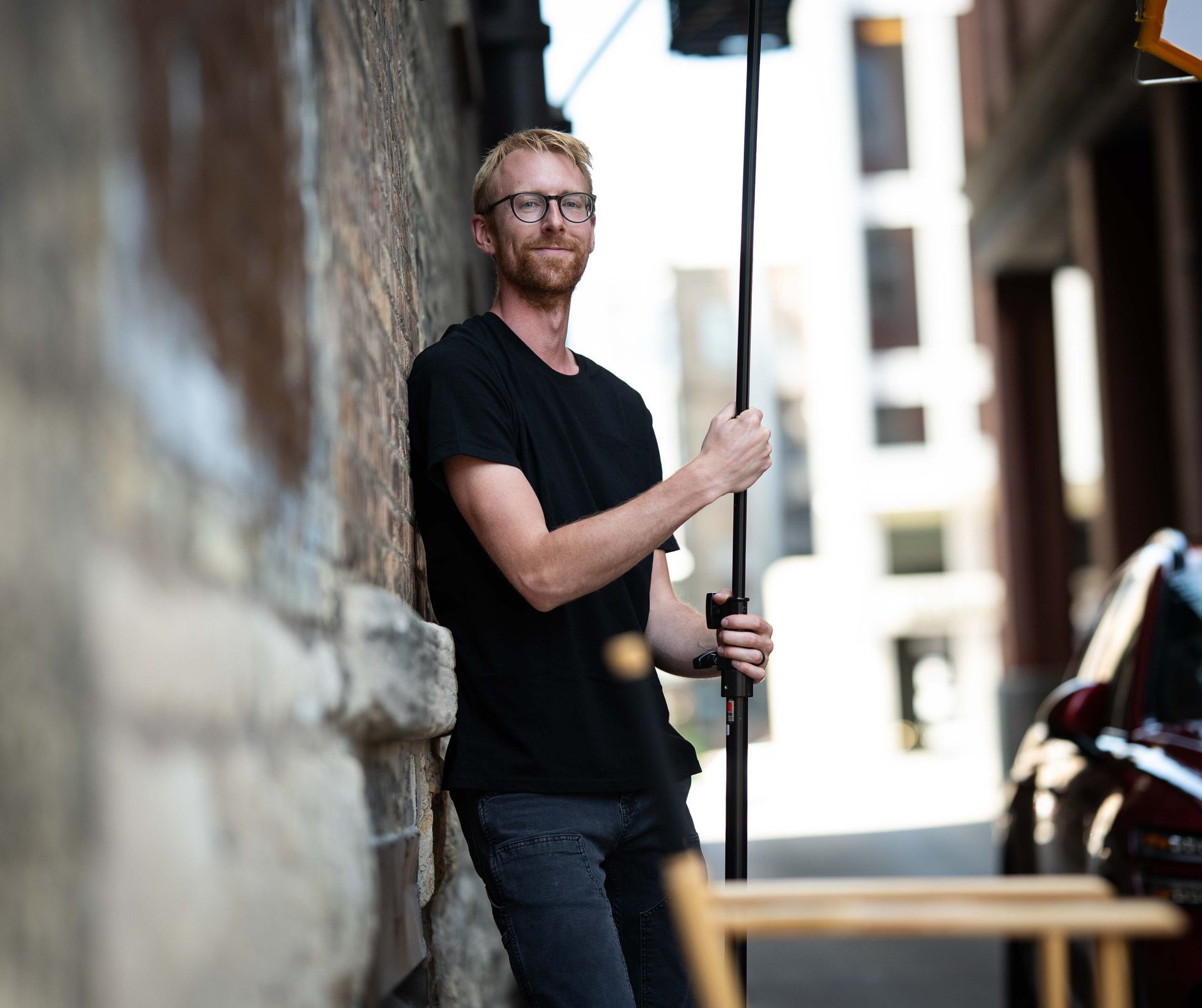 Mirrorless Productions video crew member preparing lighting equipment during a commercial filming project.