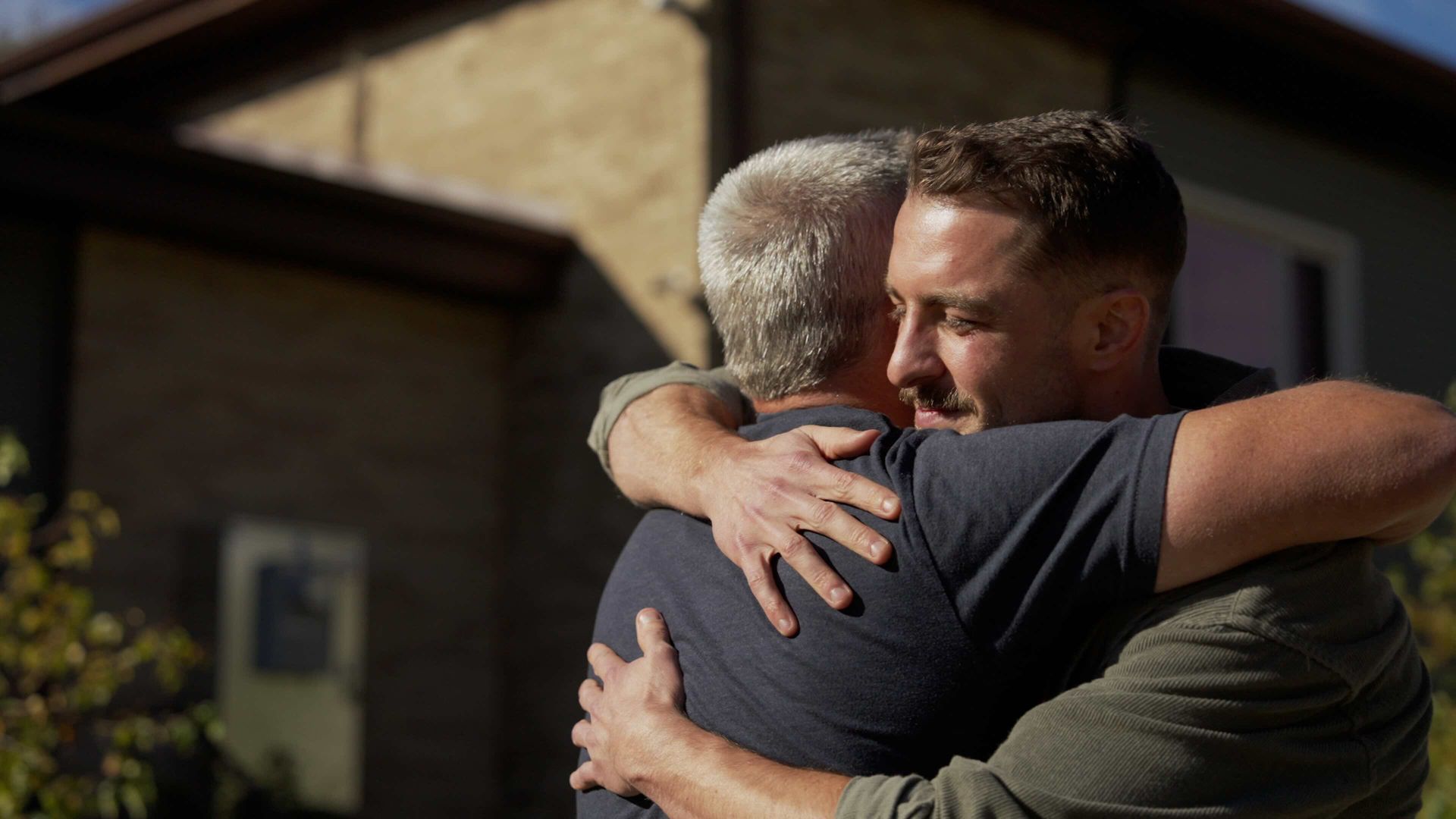 Man celebrating sobriety with an emotional embrace during a recovery awareness video production for Solutions Recovery Club.
