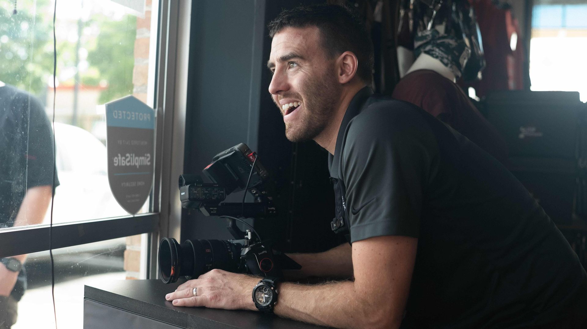 Videographer Alex Belville filming a video campaign for Project Safeguard with a professional cinema camera on location.