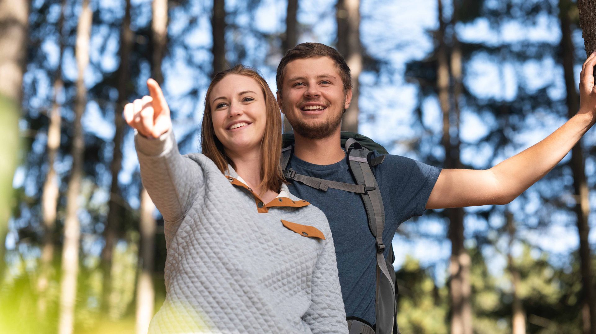 Wisconsin couple hiking on a scenic trail during a lifestyle photography session for a tourism marketing campaign.