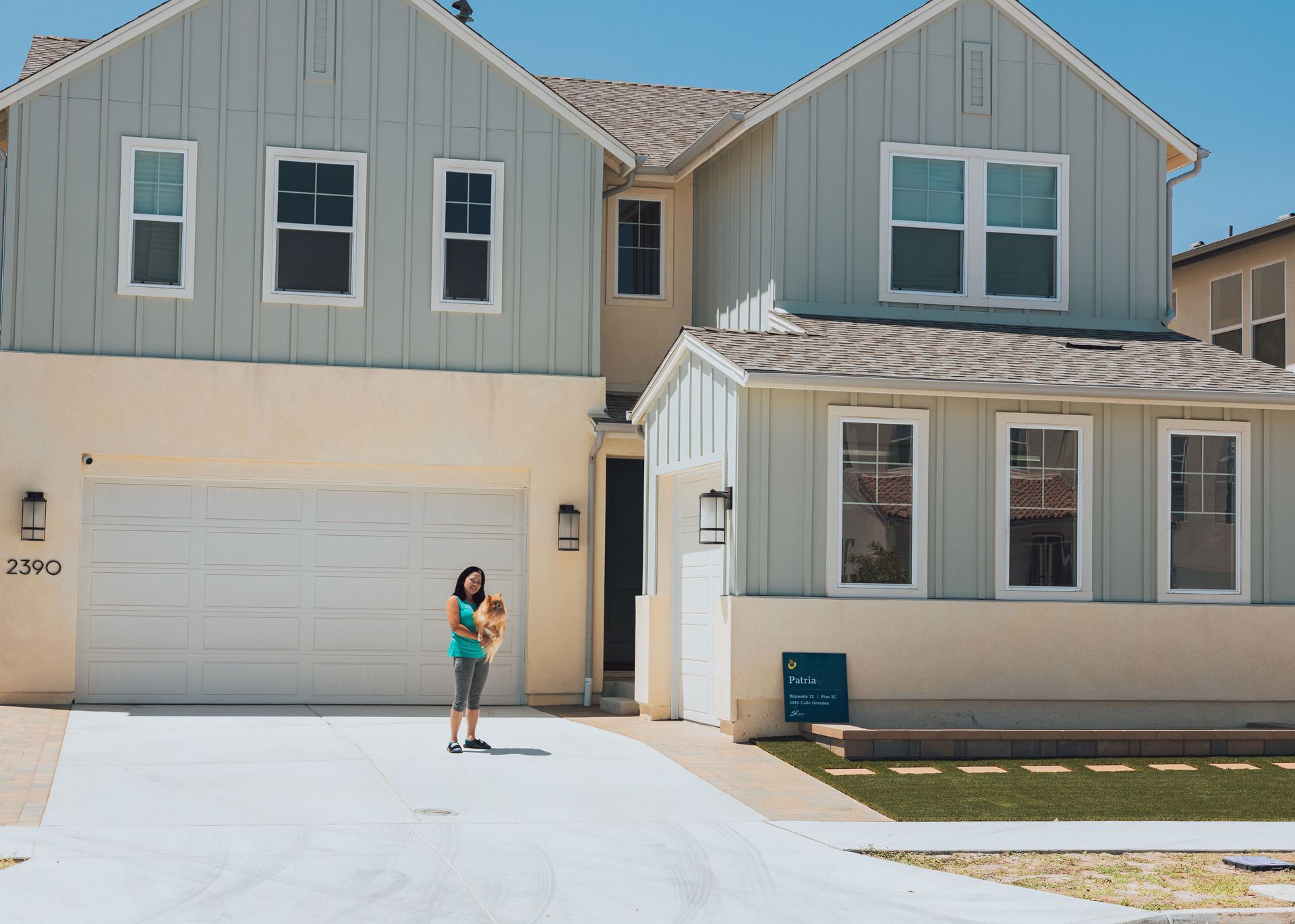 homeowner standing beside newly installed concrete driveway at san diego residence