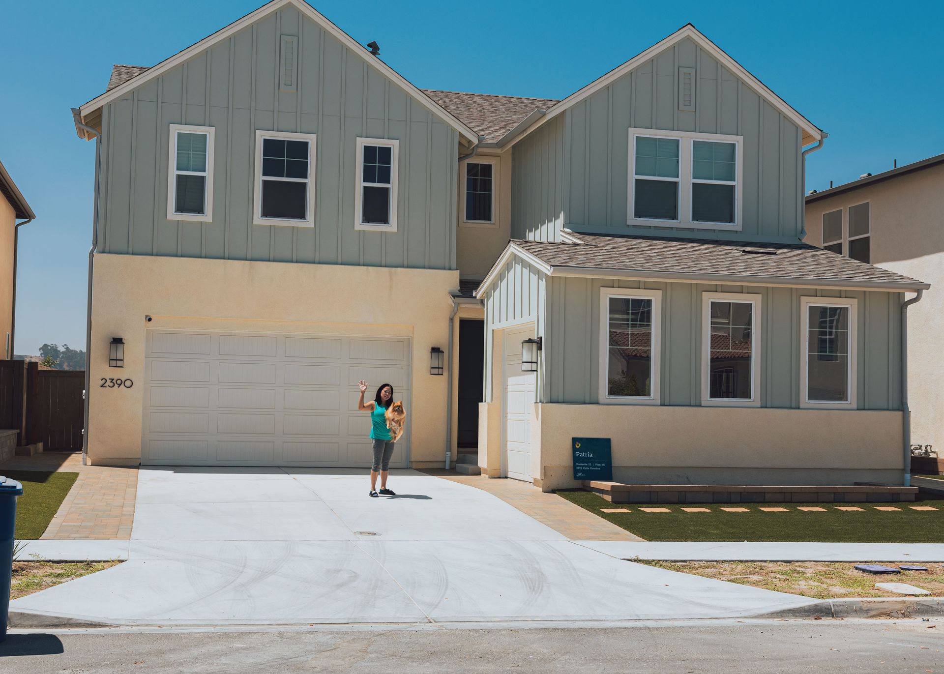 Happy homeowner with newly installed concrete driveway in San Diego