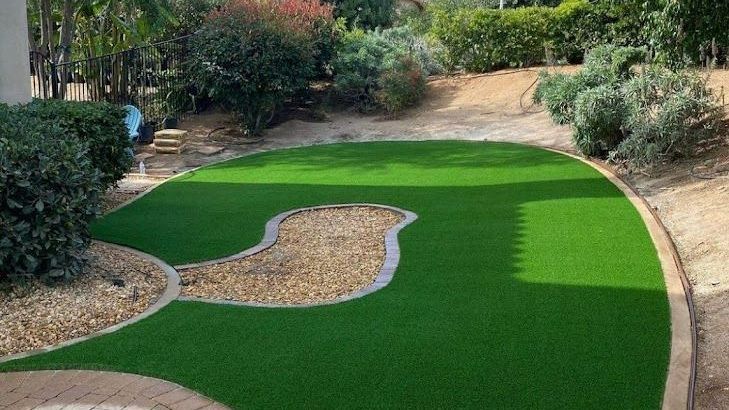 Patio area featuring professional artificial turf installation in San Diego