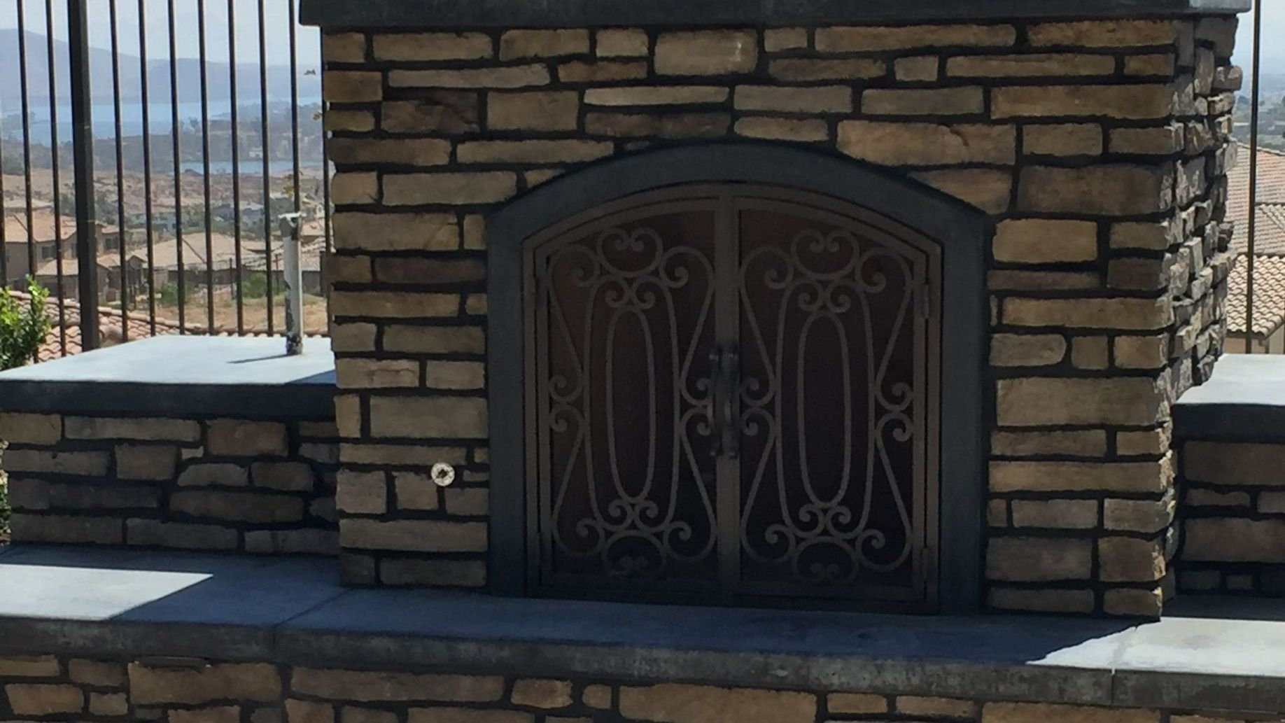 Outdoor kitchen with built-in grill and bar seating in Mt. Helix
