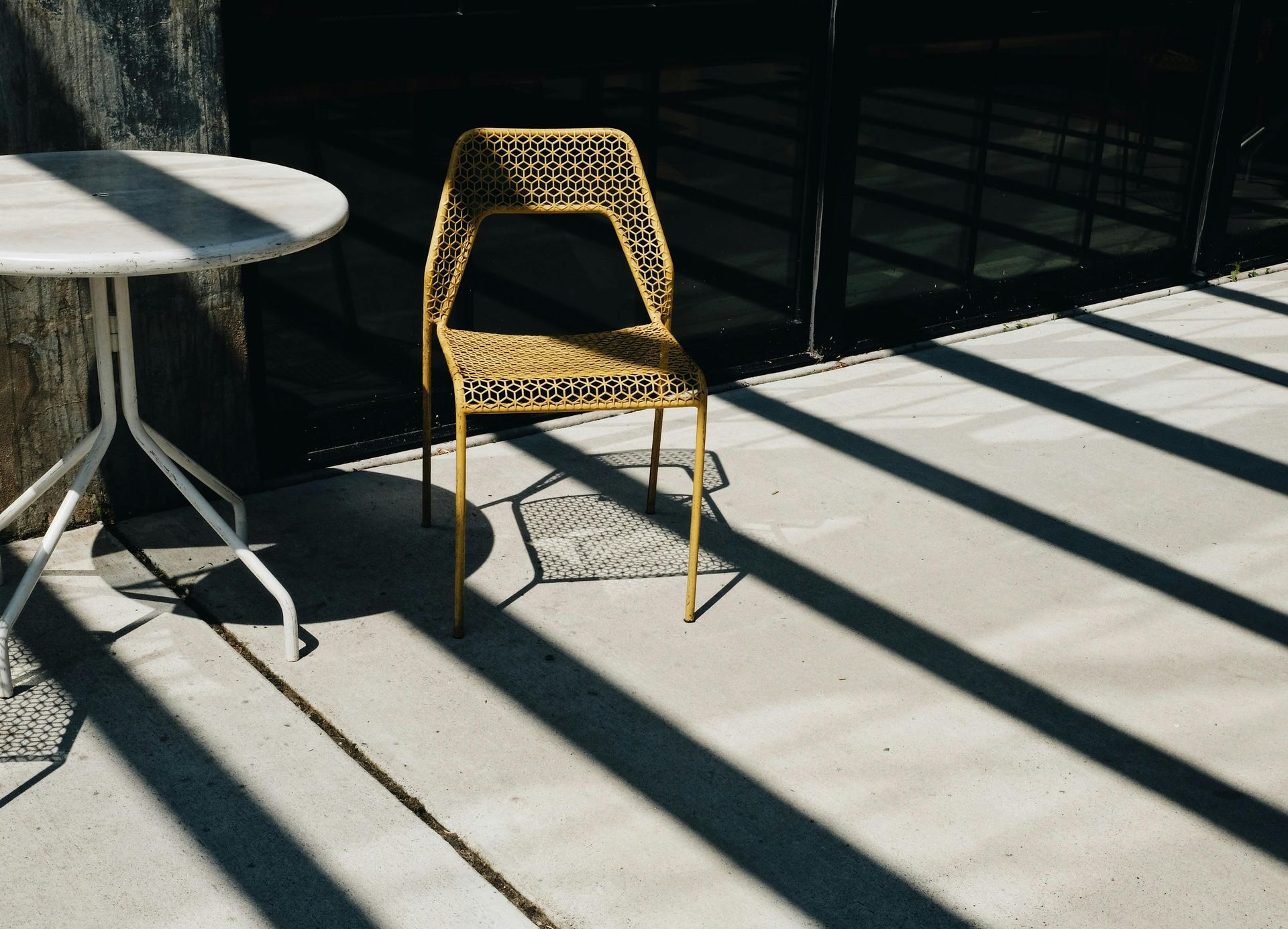 Broom finished concrete patio with covered seating area in a San Diego backyard