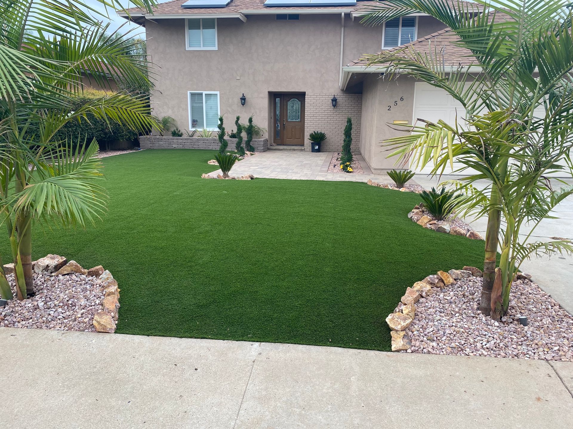 Front house San Diego landscape design with turf, plants, and decorative pavers