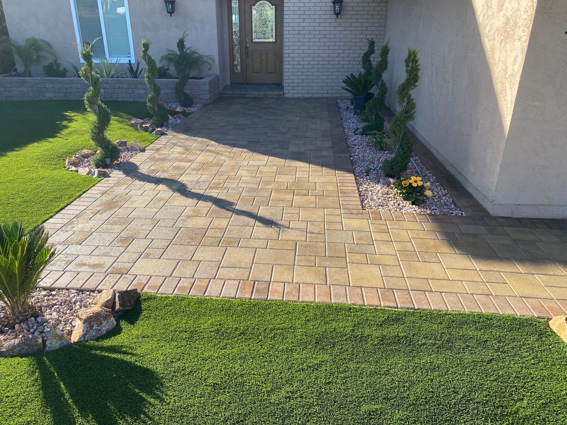 landscaping team installing pavers for patio project in San Diego