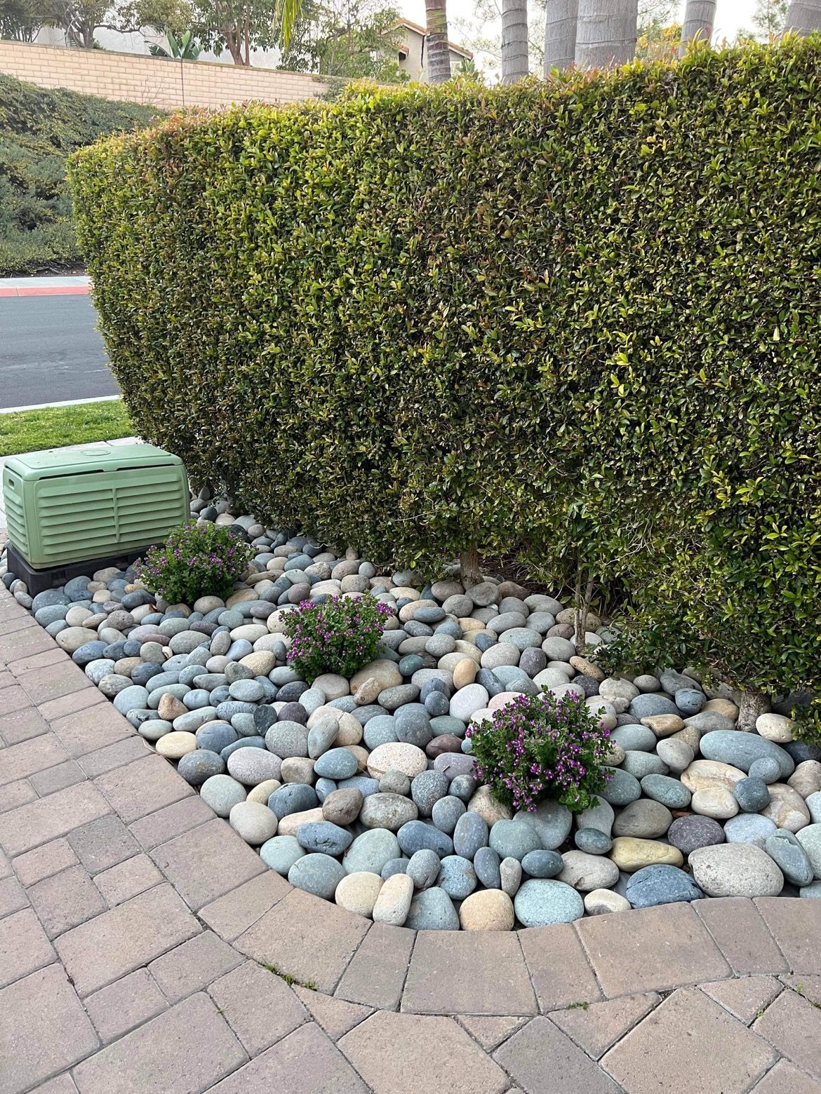 front yard landscaping in san diego with decorative rock shrubs and modern planters