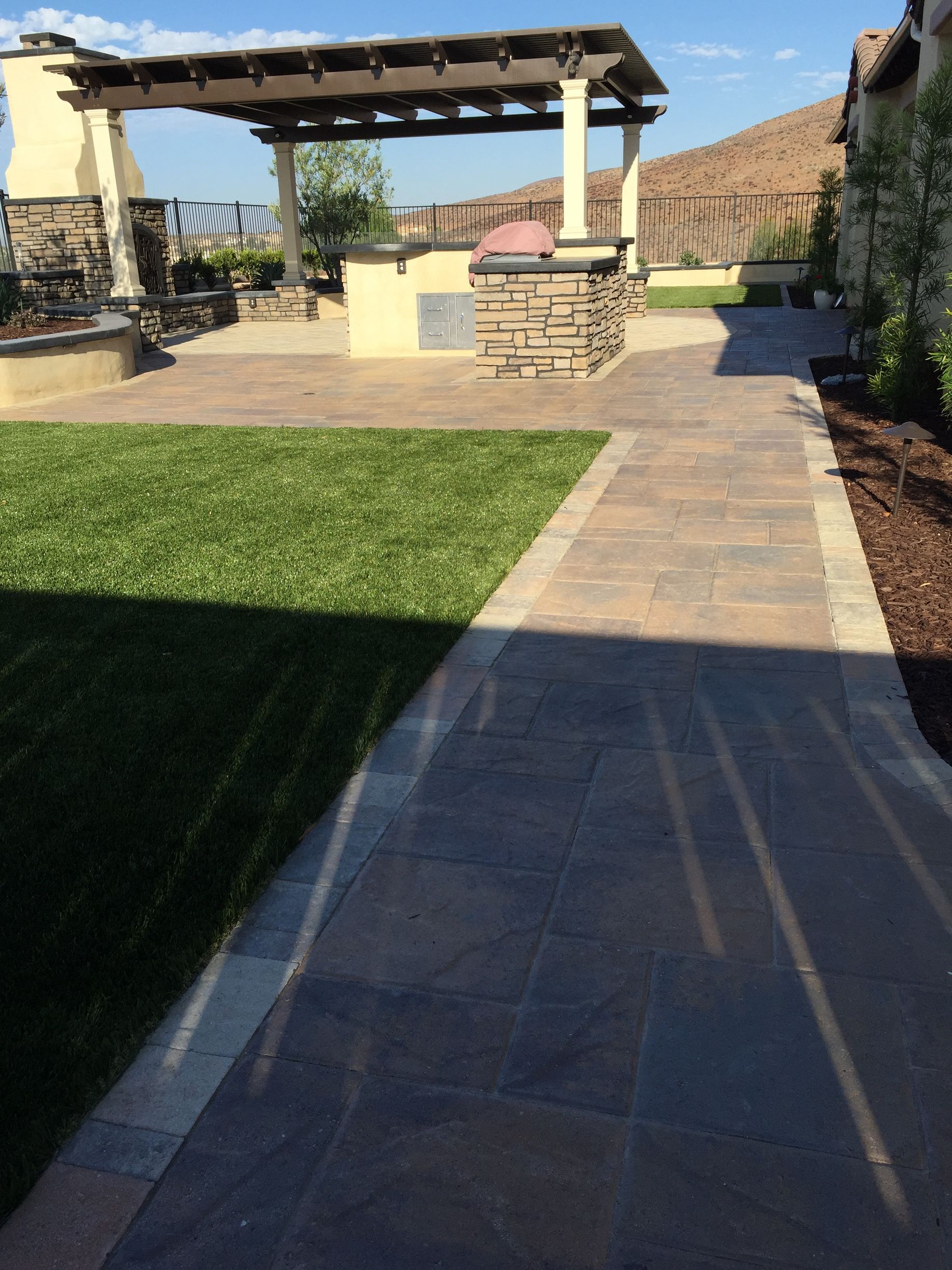 Turf and pavers pathway professionally installed by landscapers in San Diego