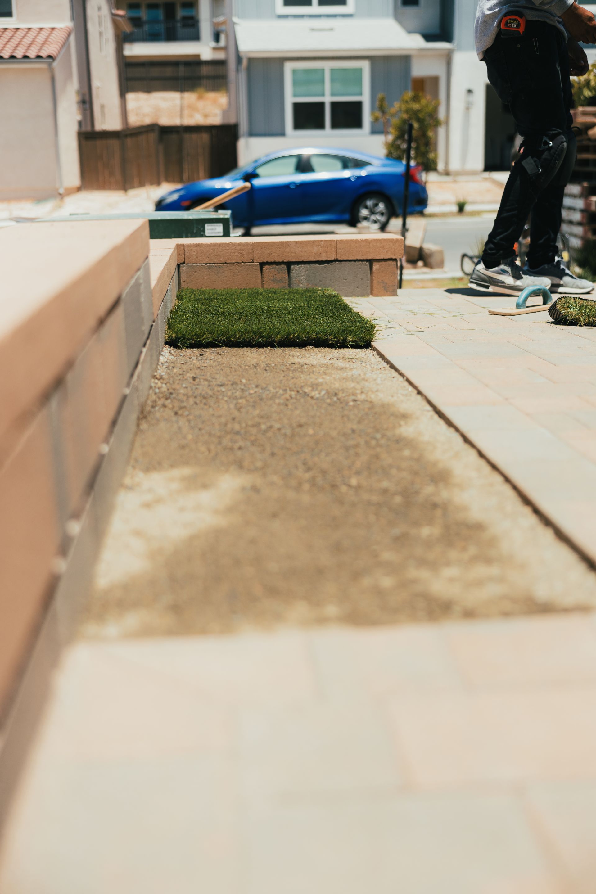 Turf installation process underway by San Diego landscaping crew