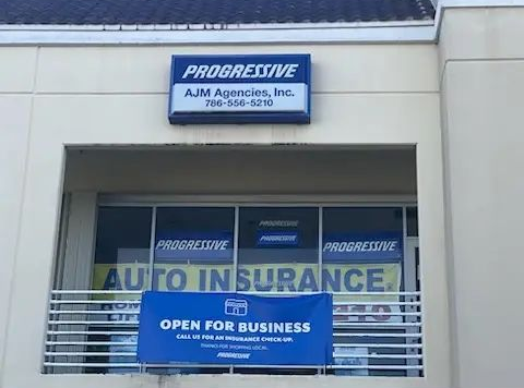Storefront for Progressive All American Agency, Inc. with auto insurance signs and open-for-business banner