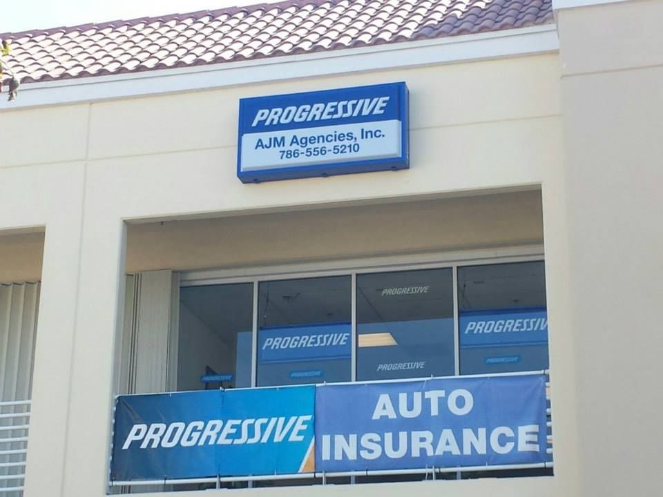 Progressive Auto Insurance storefront sign above a blue banner on a building exterior
