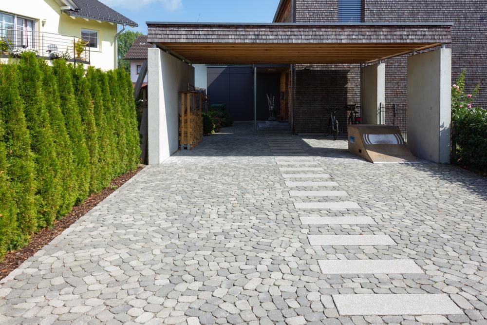A Brick Driveway Leading to A House with A Carport — Bundy Tiny Homes and Carports in Burnett Heads, QLD