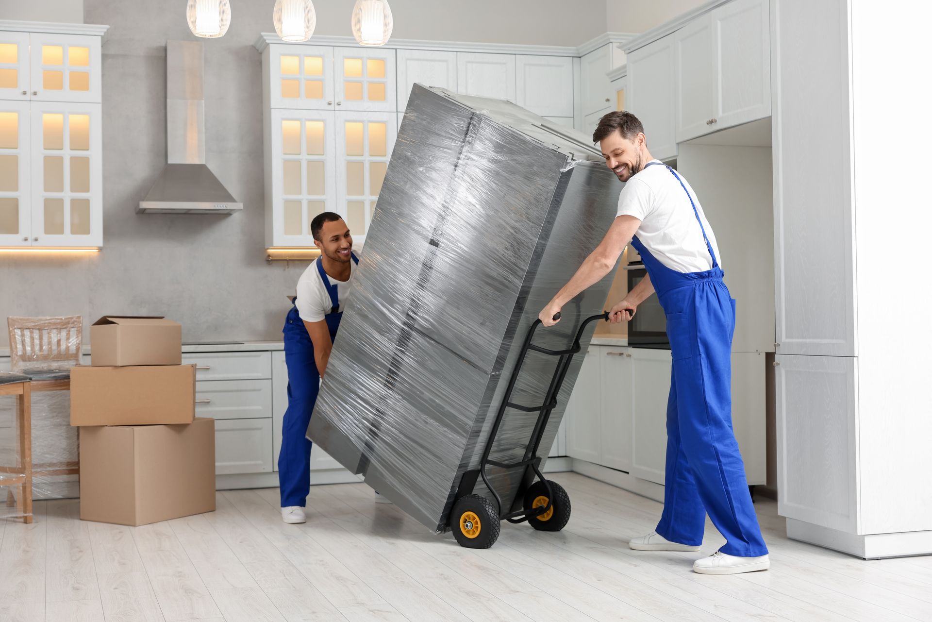 Two men are loading boxes into a moving truck.