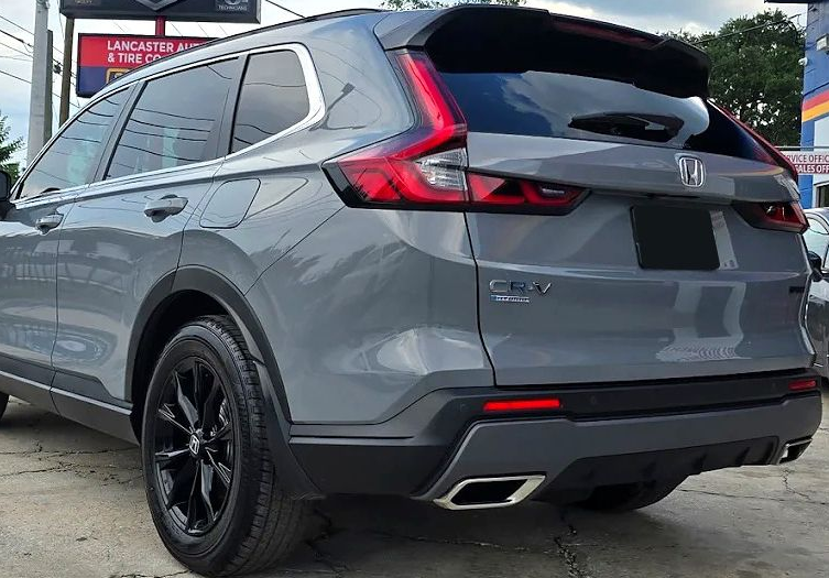 Gray Honda SUV shown from the rear in a parking lot, with black wheels and red taillights.