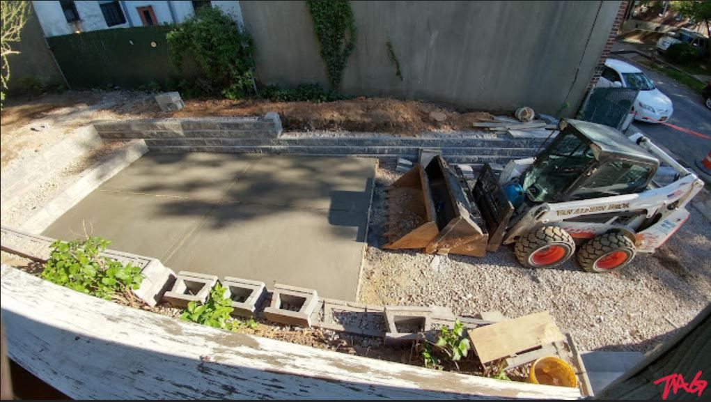 An aerial view of a construction site with a bobcat in the foreground. An aerial view of a construction site with a bobcat in the foreground.