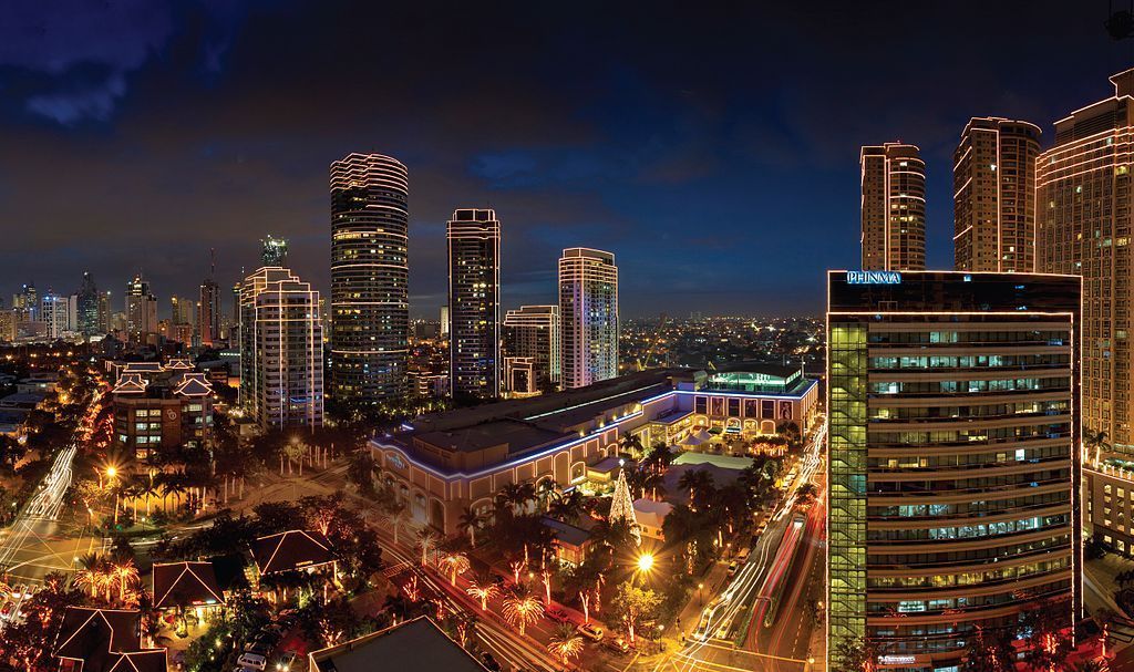 Makati skyline at dusk with city lights near family staycation makati hotels.