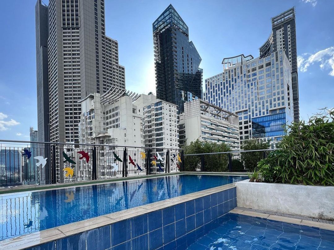 Rooftop swimming pool with Makati skyline views at staycation hotels makati with pool.