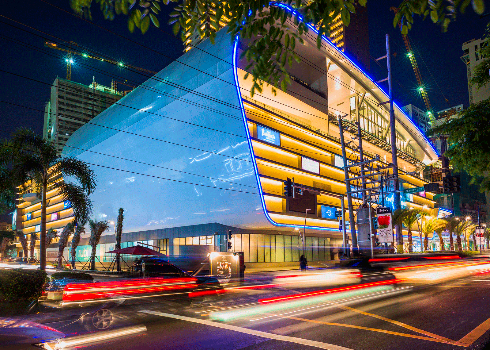Evening cityscape of Century City Mall illuminated at night in Makati.