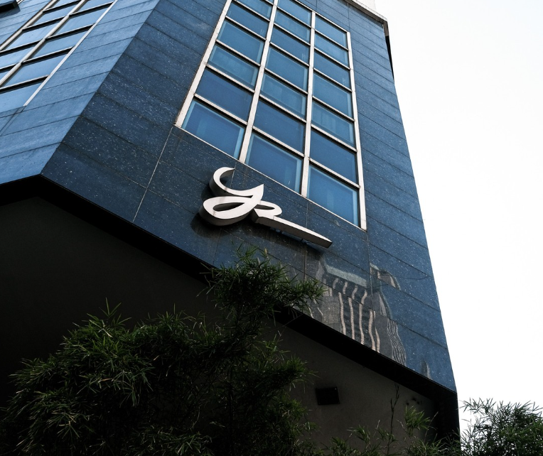 Modern high-rise building with glass exterior in Makati business district.