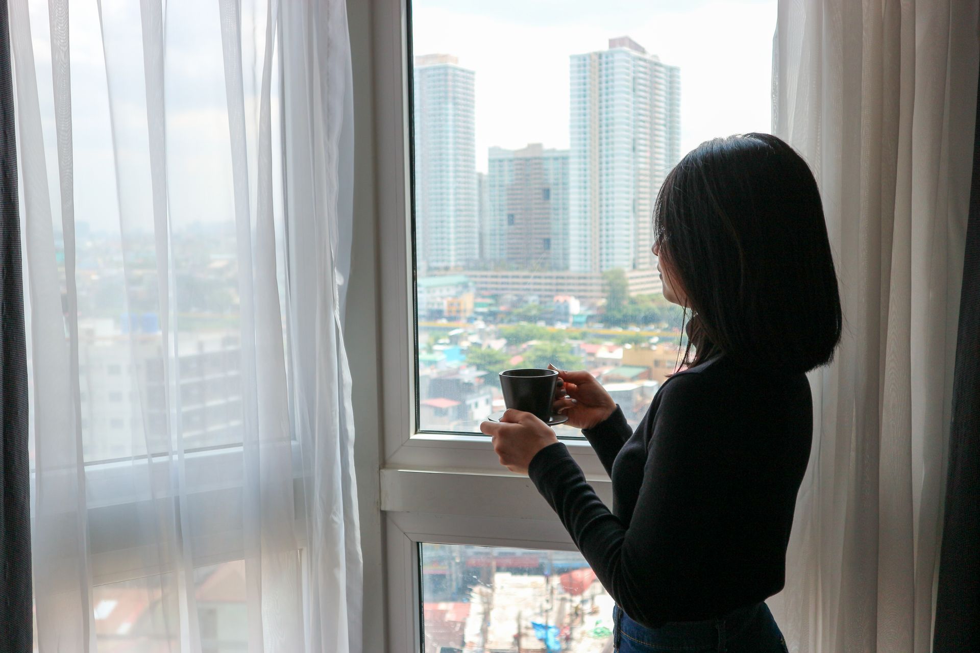 First-timer enjoying coffee with a Makati skyline view from her room at Y2
