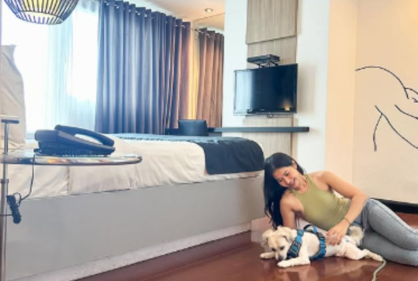 Guest bonding with pet at Y2 Residence Hotel, a pet-friendly hotel in Makati offering cozy accommodations