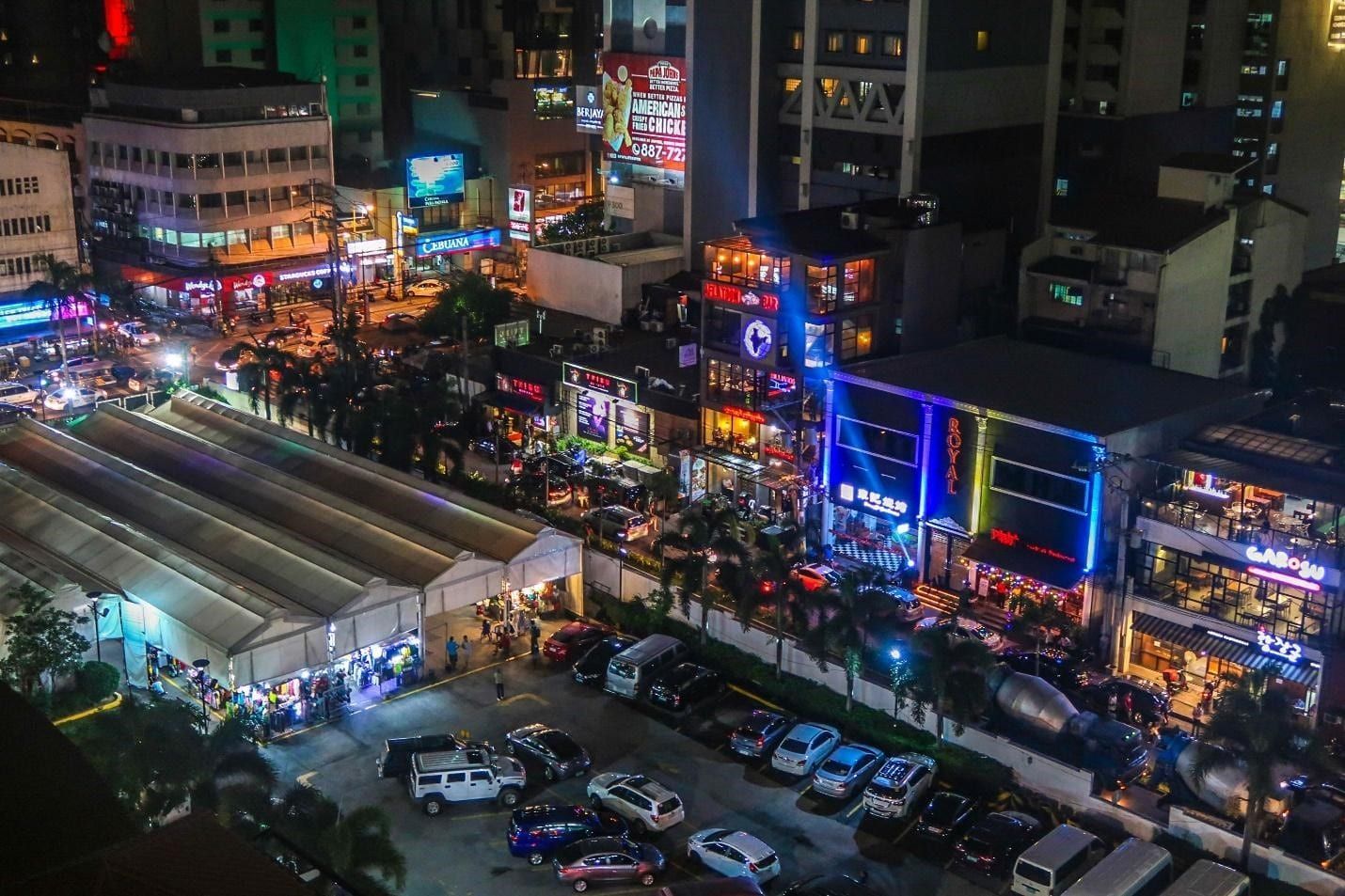 Aerial night view of vibrant Makati city streets near Y2 Residence Hotel
