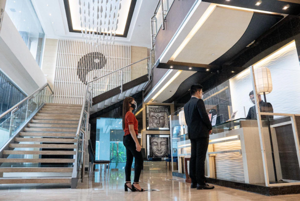 Staff welcoming guests at pet-friendly Y2 Residence Hotel Makati's modern lobby entrance