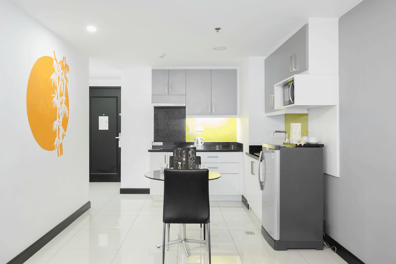 Contemporary living area with yellow décor at best hotel staycation makati.
