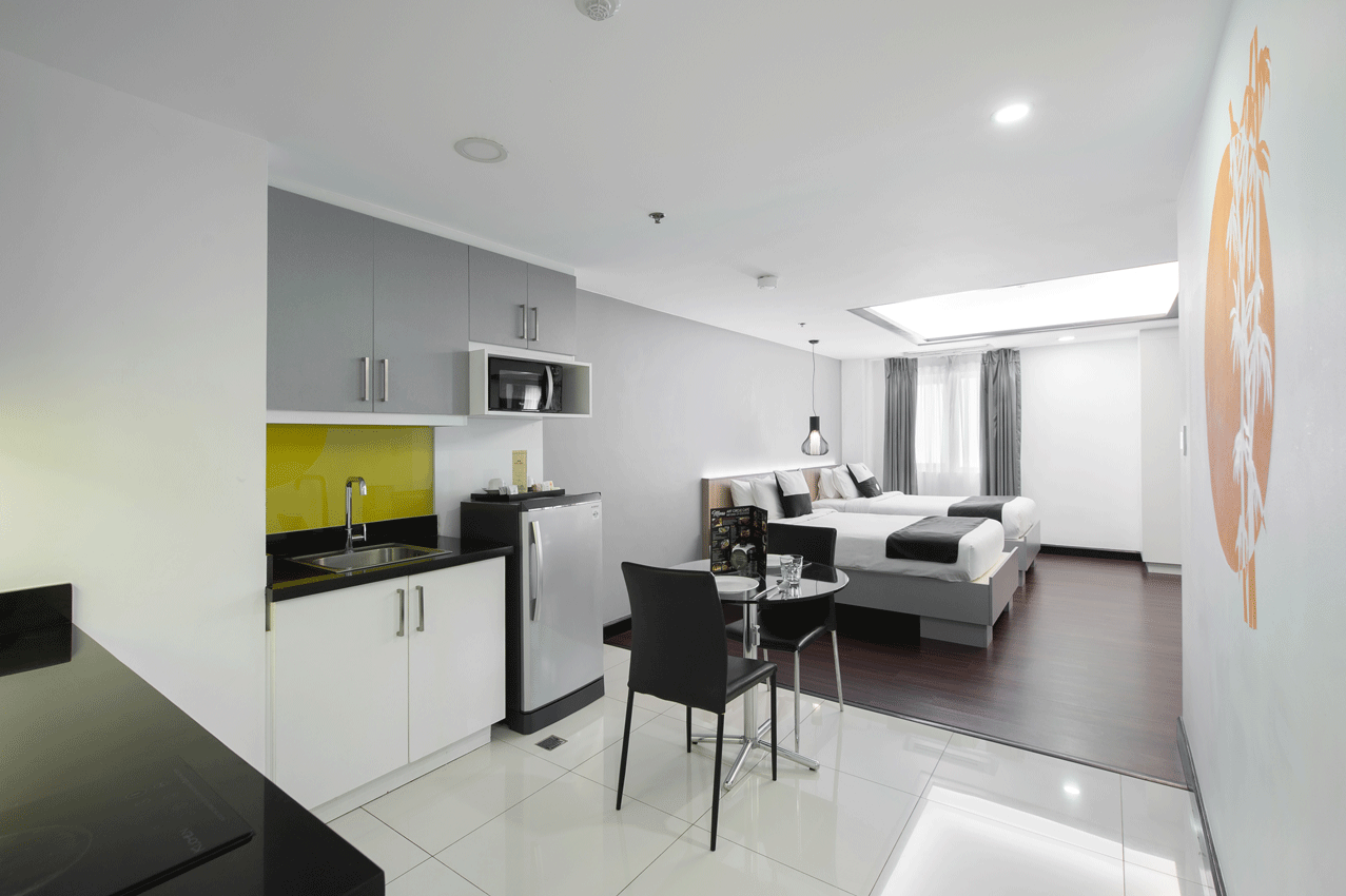 Open concept bedroom and living space at staycation hotels makati with pool.