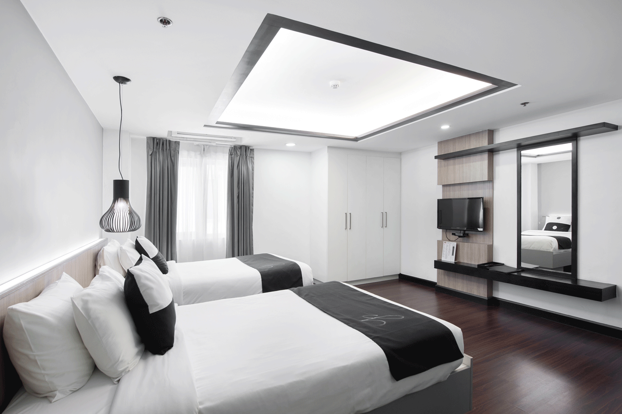 Contemporary bedroom with neutral tones at best hotel staycation makati.