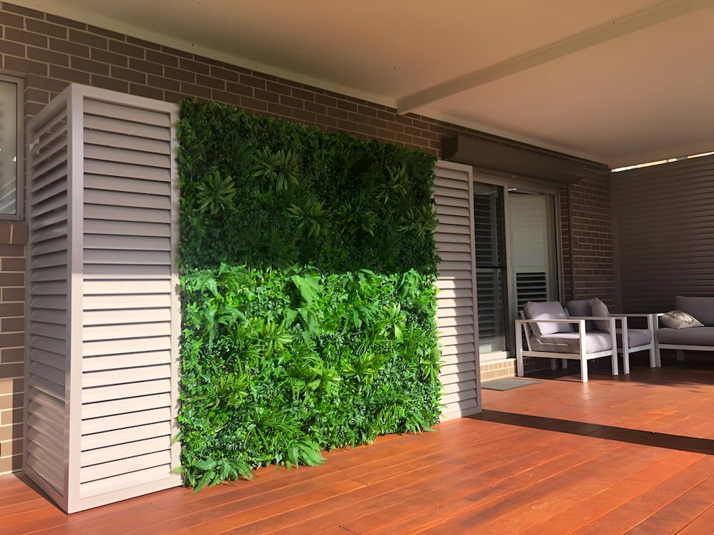 A Patio With a Green Wall and a Wooden Floor — SCF Industries Pty Ltd in Albion Park, NSW