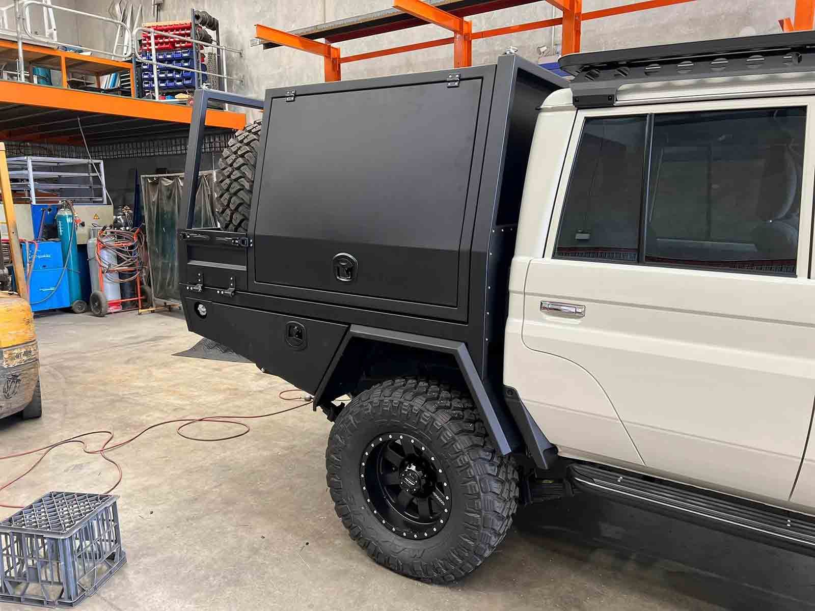 A White Truck With a Black Canopy is Parked in a Garage — SCF Industries Pty Ltd in Albion Park Rail, NSW