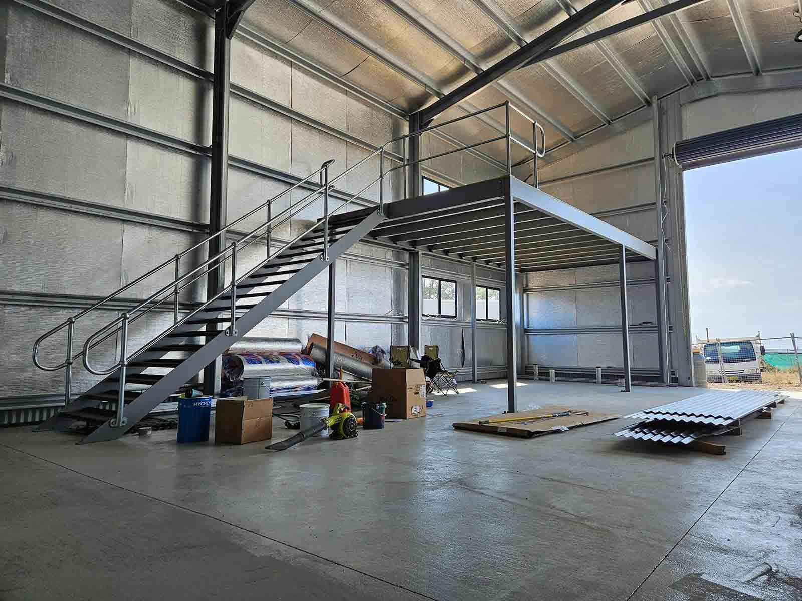 A Large Warehouse With Stairs Leading Up to a Second Floor— SCF Industries Pty Ltd in Albion Park Rail, NSW