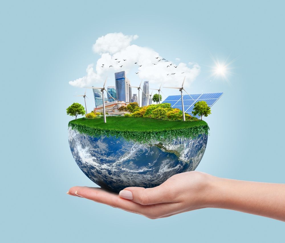 A hand is holding a globe with a city on it.