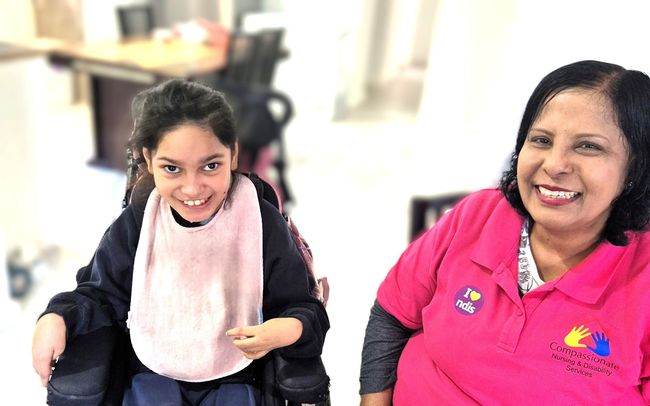 Assistance for Disabled Care disabled child in a wheelchair with a care assistant
