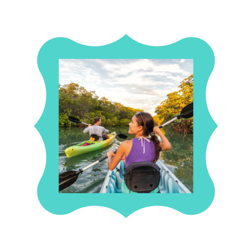 A woman sitting in a kayak on a river.