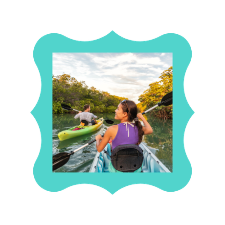 A woman sitting in a kayak on a river.