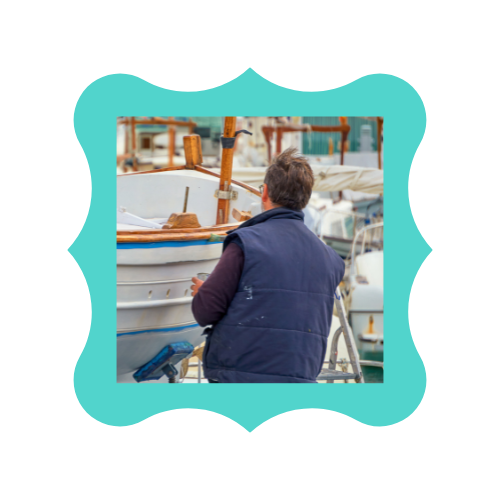 A man is working on a boat in a harbor.