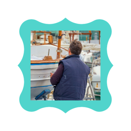 A man is working on a boat in a harbor.