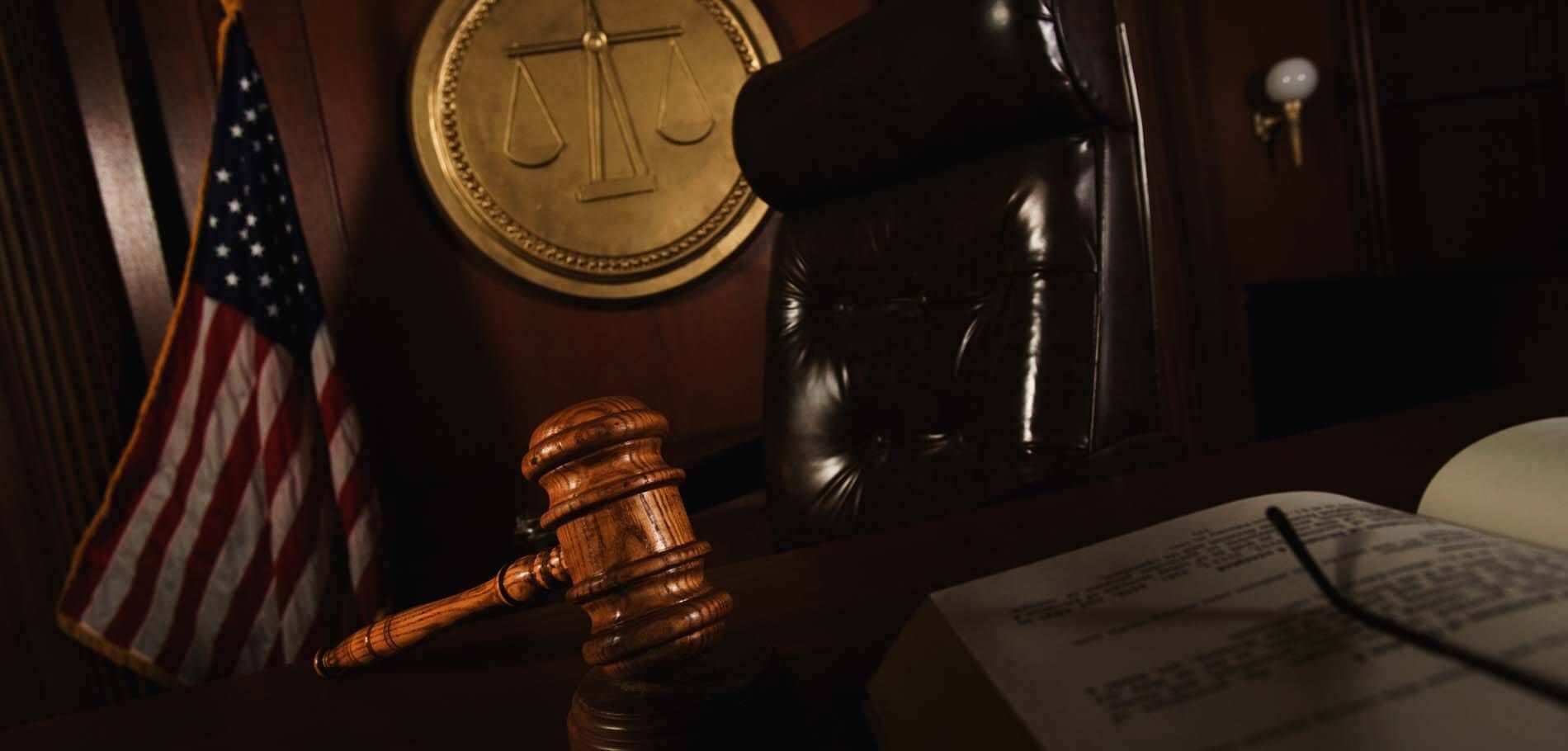 A judge 's gavel is sitting on a table in a courtroom.