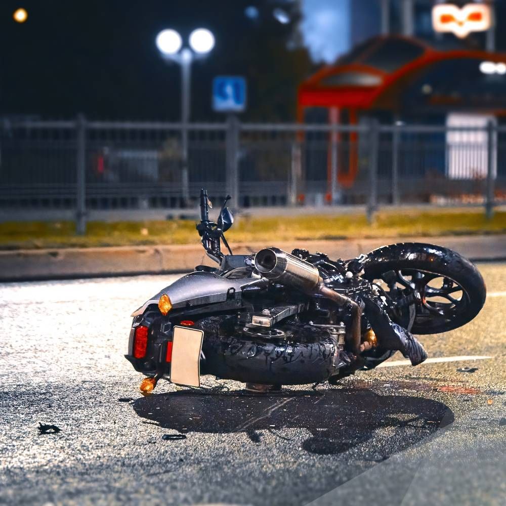 A motorcycle has crashed on the side of the road.